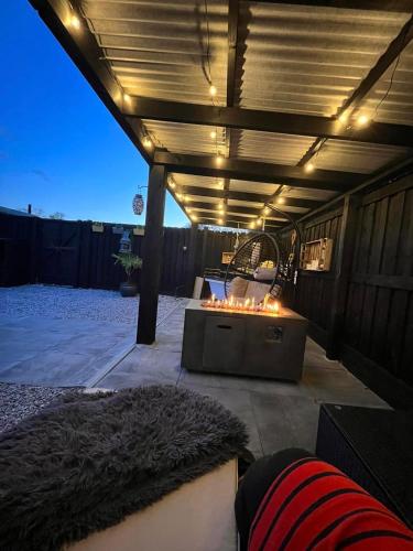 a patio with a hot tub with lights on it at The Carriage at Creagan in Creagan