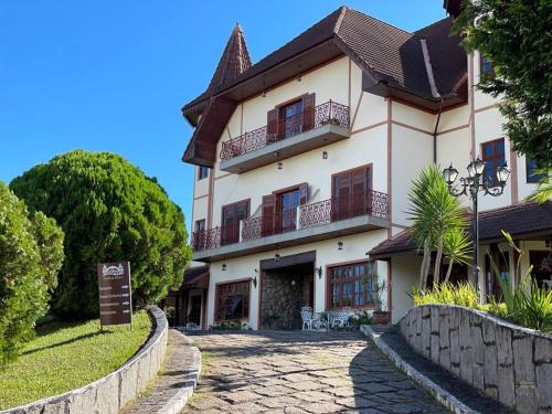 a large building with a sign in front of it at Chateau Palace in São Lourenço