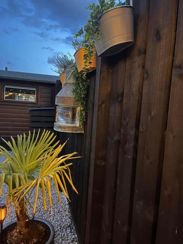 a wooden fence with potted plants on it at The Carriage at Creagan in Creagan