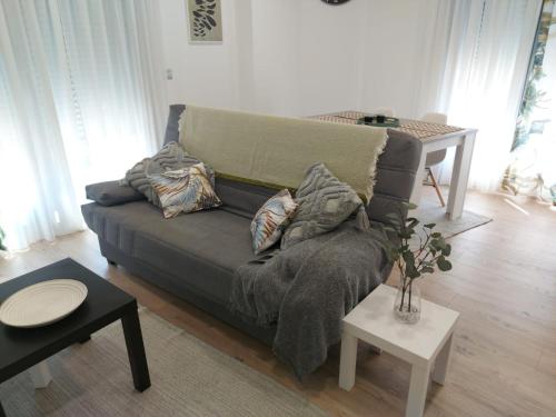 a living room with a couch and a table at Casa en piedra (Stone House) in Porriño