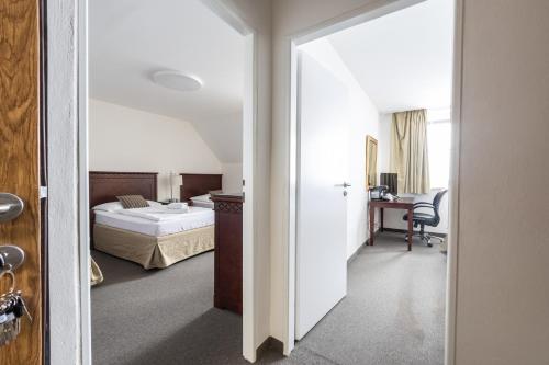 Postel nebo postele na pokoji v ubytování Hotel Petrovy kameny