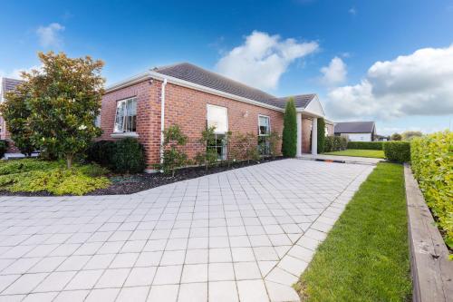 a brick house with a driveway at Sweet Magnolia 1 or 2 BR Suite St Kilda Cambridge with Complimentary Continental Breakfast in Cambridge