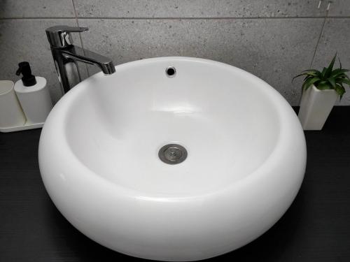 a white sink with a faucet in a bathroom at Ive Andrica 3 in Višegrad