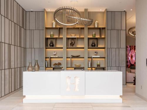 a store with a white counter and shelves of vases at Hyde Beach House - 2BD-2BA MANSION WITH DIRECT OCEAN VIEW, Resort Amenities, Rooftop Pool and Hot tub, Tennis court, few min walk to the ocean in Hollywood