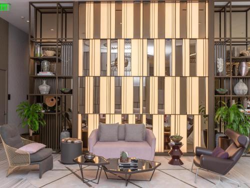 a living room with a couch and two chairs at Hyde Beach House - 2BD-2BA MANSION WITH DIRECT OCEAN VIEW, Resort Amenities, Rooftop Pool and Hot tub, Tennis court, few min walk to the ocean in Hollywood