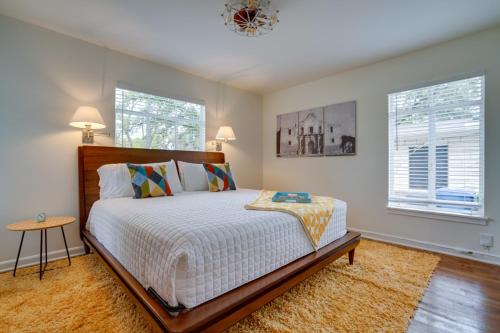 a bedroom with a large bed and two windows at San Antonio Vacation Rental about 7 Mi to River Walk! in San Antonio