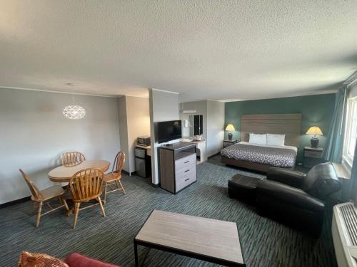 a hotel room with a bed and a living room at Countryside Inn & Suites Omaha East-Council Bluffs IA in Council Bluffs