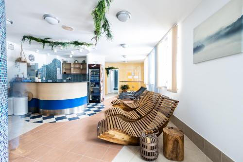 a living room with two chairs and a counter at Hotel Petrovy kameny in Karlova Studánka