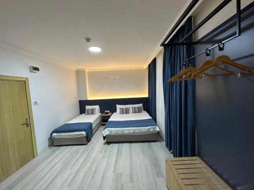 a bedroom with two beds and a window in it at Enda Lara Hotel in Antalya