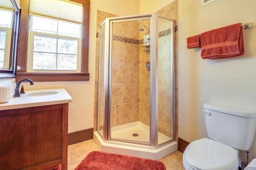 a bathroom with a shower and a toilet and a sink at Spacious Manitou Home with Views in Central Location in Manitou Springs