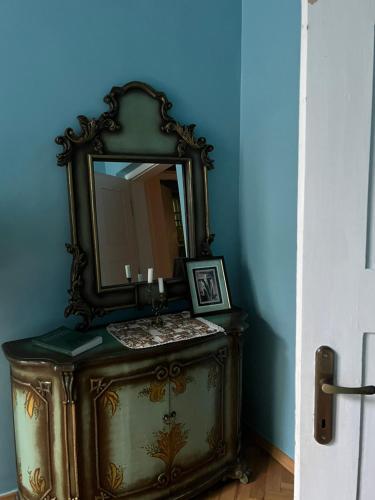 a mirror on top of a dresser in a room at Willa Starówka in Nałęczów