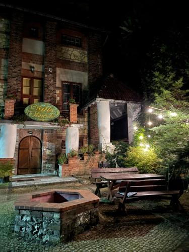 a bench in front of a building at night at Willa Starówka in Nałęczów