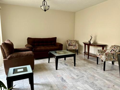 a living room with couches and tables at GRAN CASA para vacacionar in Durango