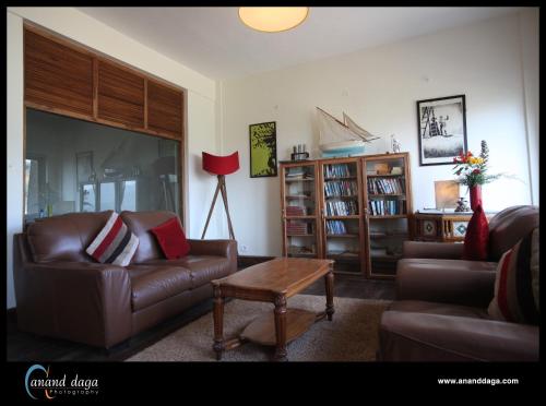 a living room with two couches and a table at Destiny - The Farm Resort in Ooty