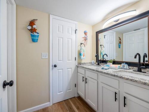 a bathroom with a sink and a large mirror at Englewood, Manasota Keys - 2 Bedroom Luxury Villa, Pool, Game room, 6 min to Beaches next to Canal in Englewood