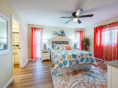 a bedroom with a bed and a ceiling fan at Englewood, Manasota Keys - 2 Bedroom Luxury Villa, Pool, Game room, 6 min to Beaches next to Canal in Englewood