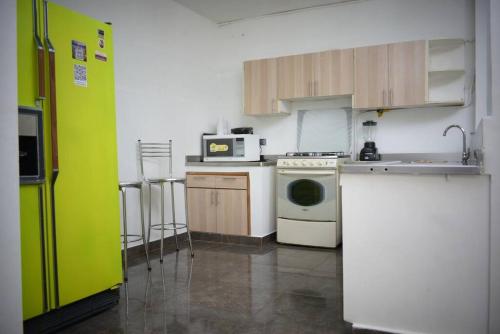 a kitchen with a white stove and a microwave at Nogales in Medellín