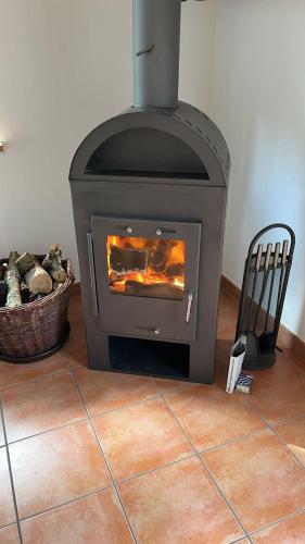 a stove in a room with a chair next to it at Ferienwohnungen Das Finkhaus in Simonsberg