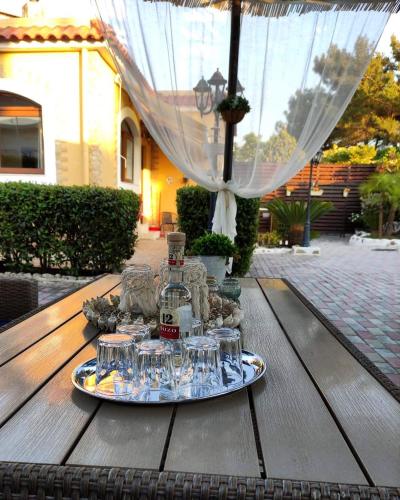 a tray of wine glasses on a wooden table at Nicole Luxury Villas in Koskinou
