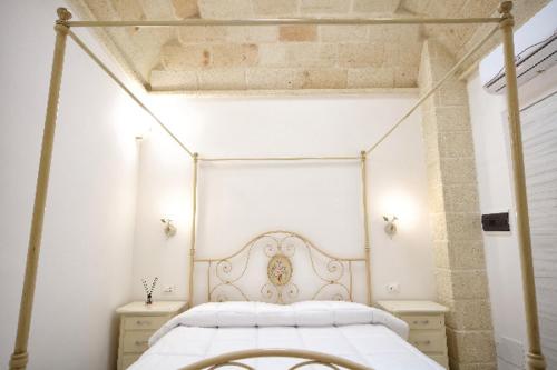a bedroom with a white bed with a metal frame at AFFITTACAMERE I PACIORRA in Favignana