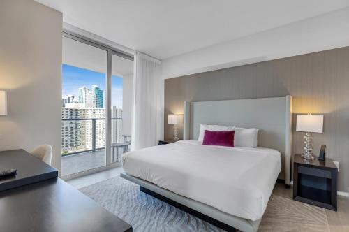 a bedroom with a large bed and a large window at Hyde Beach House - Stunning 2bd 2ba - Apt - Ocean & Intercostal views in Hollywood
