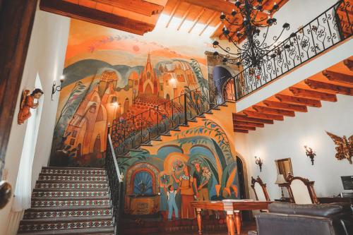 a mural on the wall of a staircase in a house at Casa Don Pascual Hotel Boutique Sweet Home in San Miguel de Allende