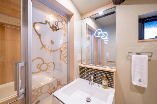 a bathroom with a sink and a mirror at RESI STAY NISHIKI in Kyoto