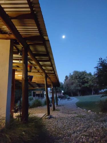 a building with a wooden roof next to a road at Cielos Abiertos in La Paz