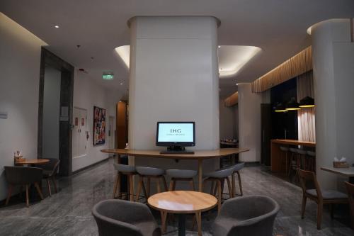 a room with a table with a computer on it at Holiday Inn Express Hyderabad HITEC City by IHG in Hyderabad