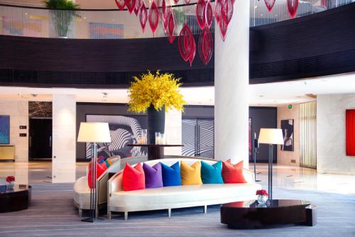 a lobby with a couch with colorful pillows at Marco Polo Wuhan in Wuhan