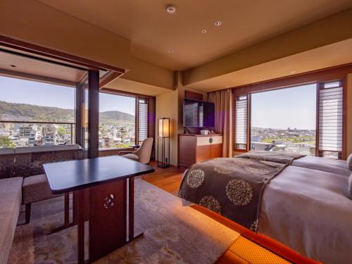 a bedroom with a large bed and a large window at Sora Niwa Terrace Kyoto Bettei in Kyoto