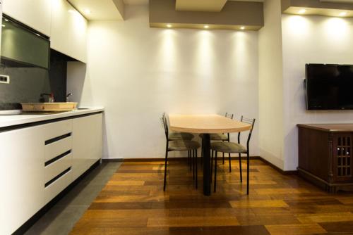 a kitchen with a table and chairs in a room at Vila Centar in Budva