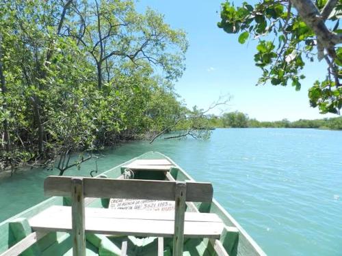 a boat on the water with a sign on it at casa jasmin in Jericoacoara