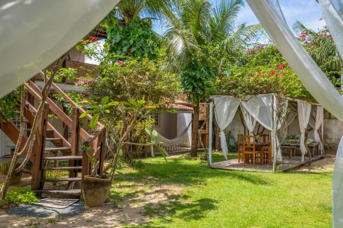 a view of the backyard of a house with a hammock at casa jasmin in Jericoacoara