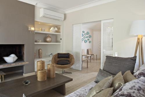 a living room with a couch and a fireplace at Hotel des Lices in Saint-Tropez