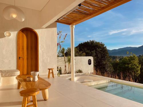 a villa with a plunge pool and a table and chairs at Villa Soll A By The Villas 100 in Bogor