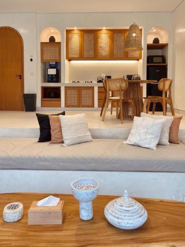a large bed with pillows and a table in a room at Villa Soll A By The Villas 100 in Bogor