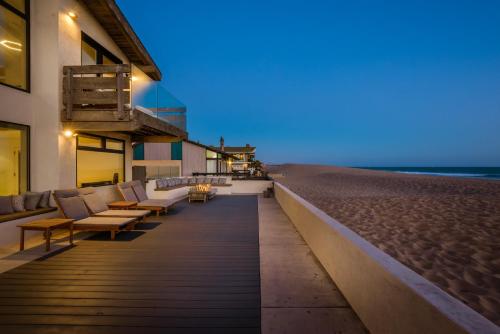 a boardwalk leading to the beach at night at Luxury Modern Designer Beach House on Sand w/ Pool in Ventura
