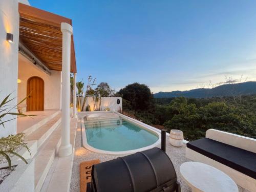 a swimming pool on the patio of a house at Villa Soll A By The Villas 100 in Bogor
