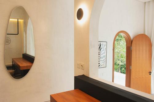 a room with a mirror and a wooden table at Villa Soll A By The Villas 100 in Bogor