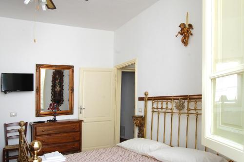 a bedroom with a bed and a mirror on the wall at Old Time Lido in Lido di Camaiore