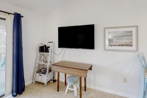 a room with a desk and a tv on a wall at Pinehurst S-8 in Little River