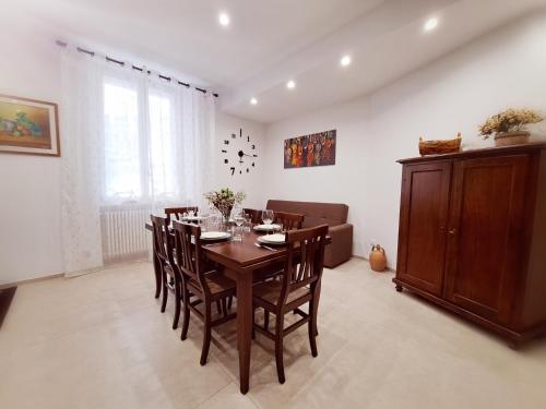 a dining room with a wooden table and chairs at Le Popolari - Appartamento in Bitonto