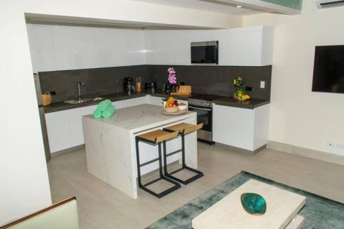a kitchen with a island in the middle of a room at Casa Kaiman - Apartment Rincon in Nosara