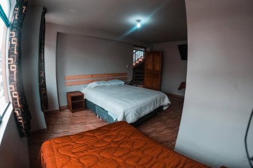 a bedroom with two beds and a window at Chacraraju Hostel in Huaraz