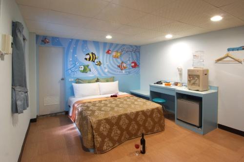 a bedroom with a bed in a room with a fish wall at Tong Bing Express in Hsinchu City