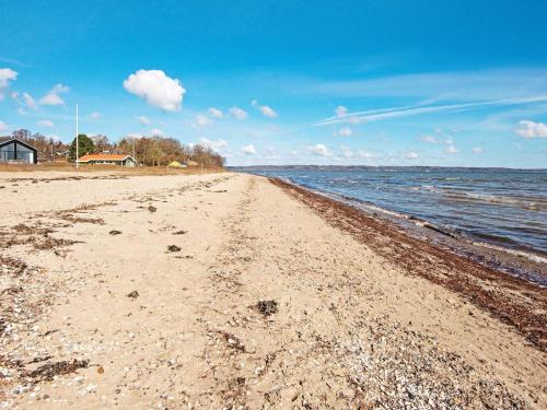 a sandy beach with a view of the ocean at Tranquil Retreat near Beach - By Traum Ferienwohnungen in Vejle