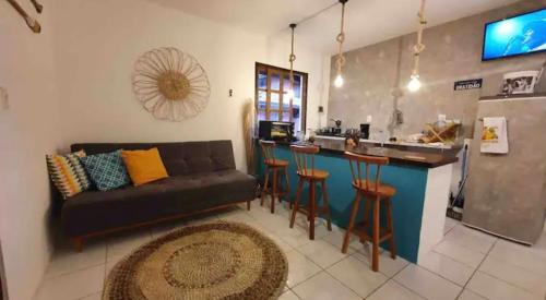 a living room with a couch and a bar at Casa Mar in Praia do Forte