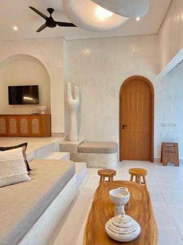 a living room with a bed and a table at Villa Soll B By The Villas 100 in Bogor