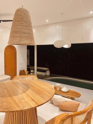 a dining room with a table and chairs at Villa Soll B By The Villas 100 in Bogor